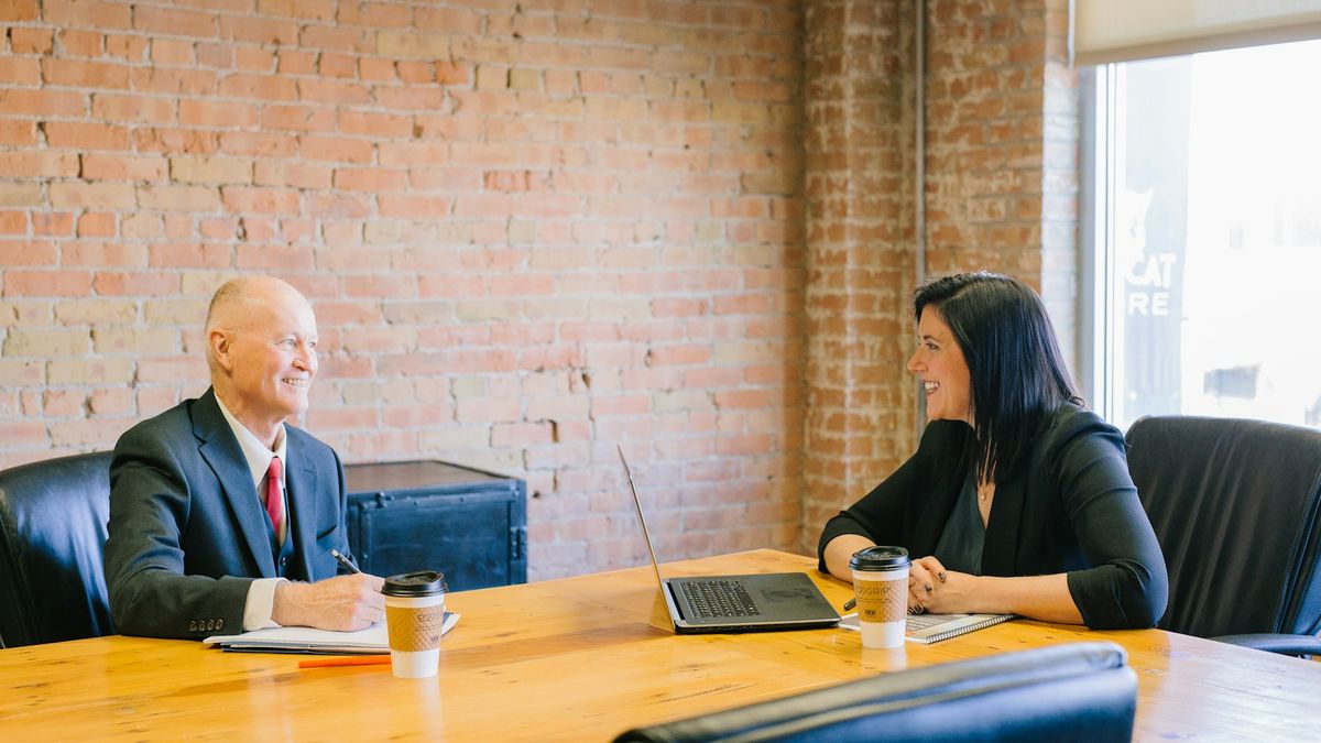 A loan officer explaining loan terms clearly to a borrower across a desk