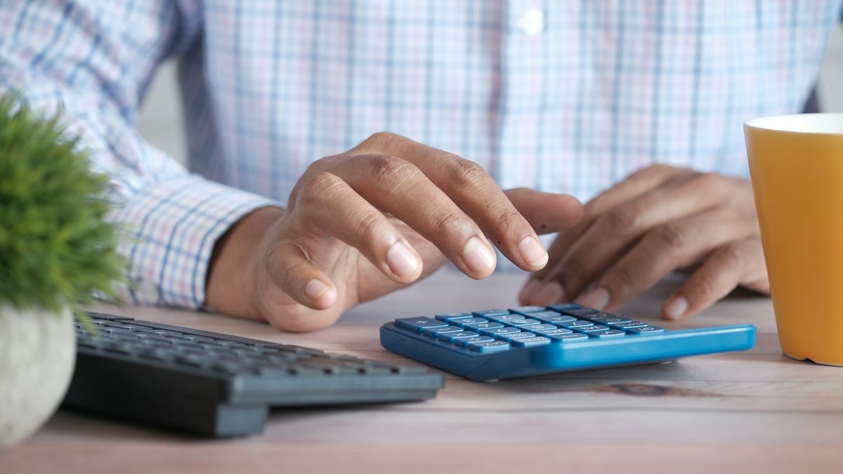Two people reviewing a cosigner loan agreement together at a table